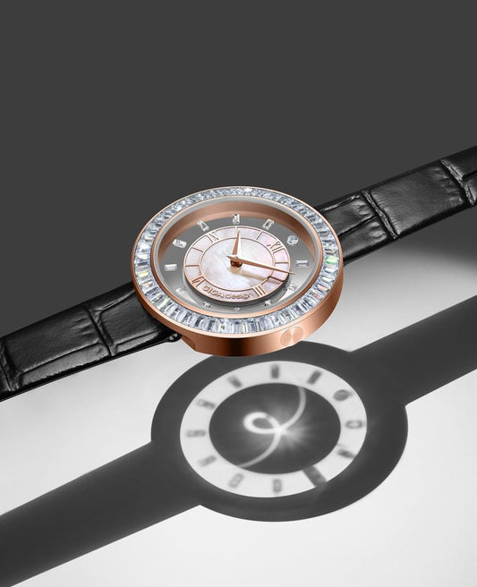 Flat-lay product shot of two sophisticated luxury designer watches with distinctive bezel designs displayed on a dark textured surface.