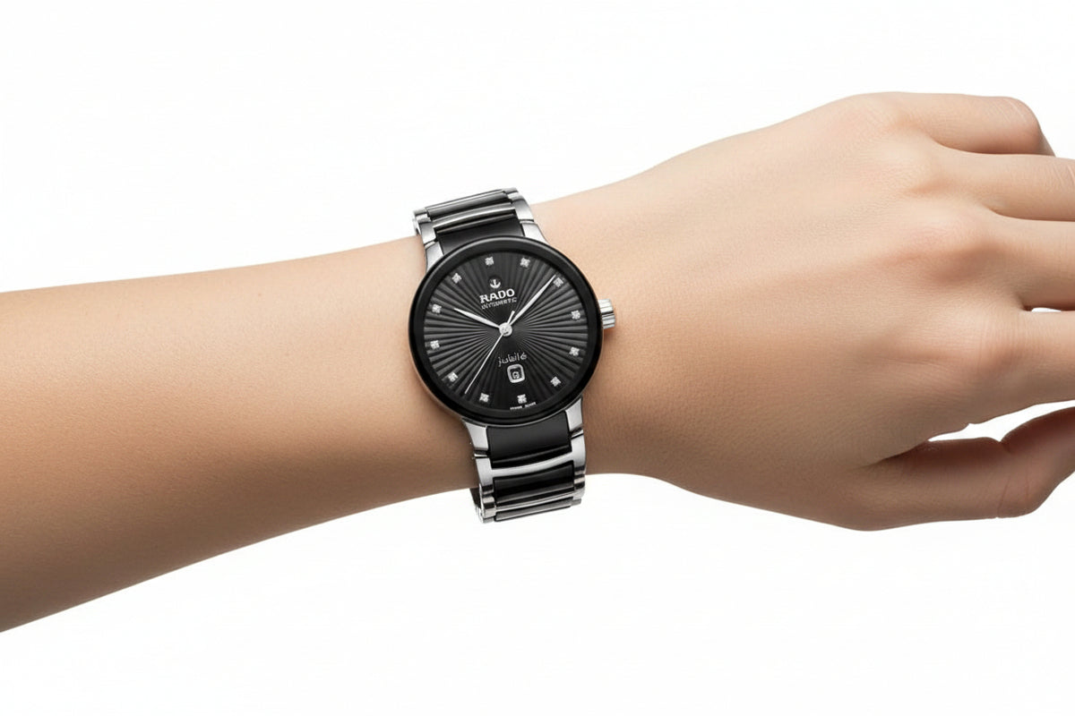 Close-up wrist shot displaying the Rado ceramic luxury watch worn on an arm, emphasizing its refined dial and bezel design.
