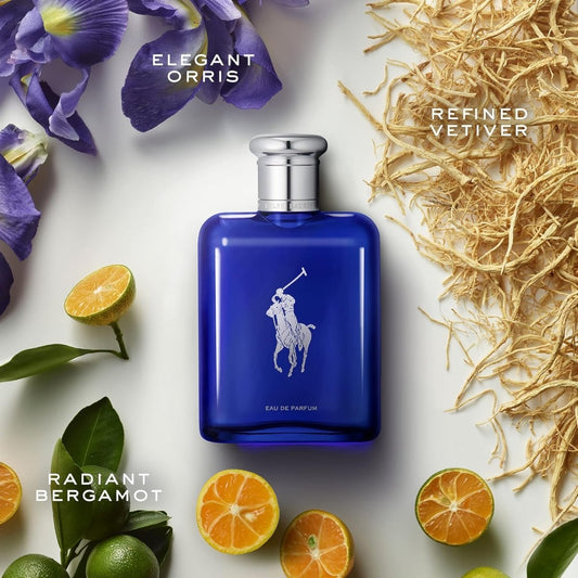 Flat-lay product shot of the Ralph Lauren Polo Blue perfume bottle surrounded by fresh citrus fruits and green botanical accents.