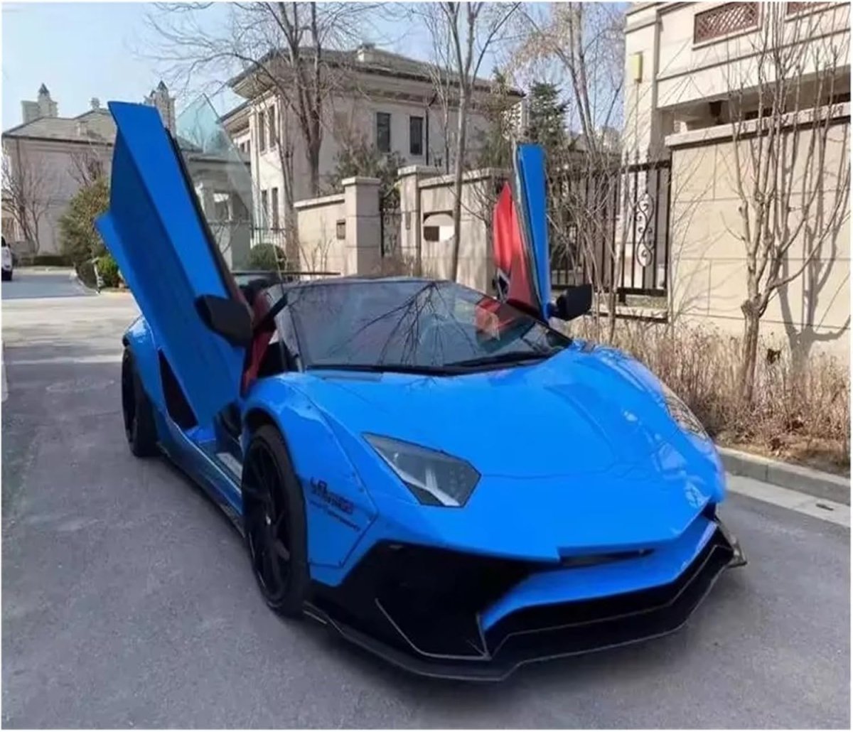 Front view of the striking blue Lamborghini Aventador supercar parked on a desert highway at sunset, with dramatic lighting.